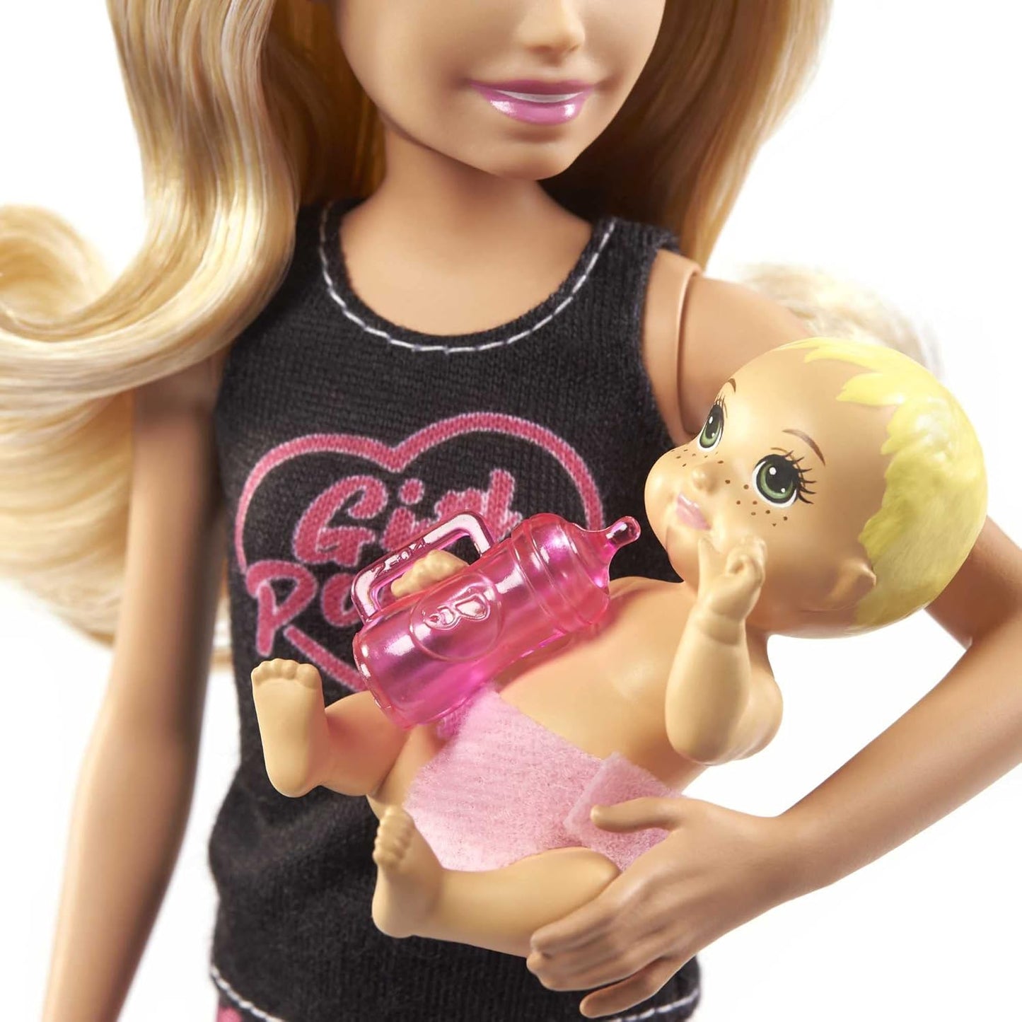 Barbie doll holding a baby doll with a pink bottle, wearing a black shirt with 'Girl Power' text.